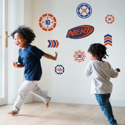 Nerf targets wall sticker pack large shown on a white wall behind two children playing