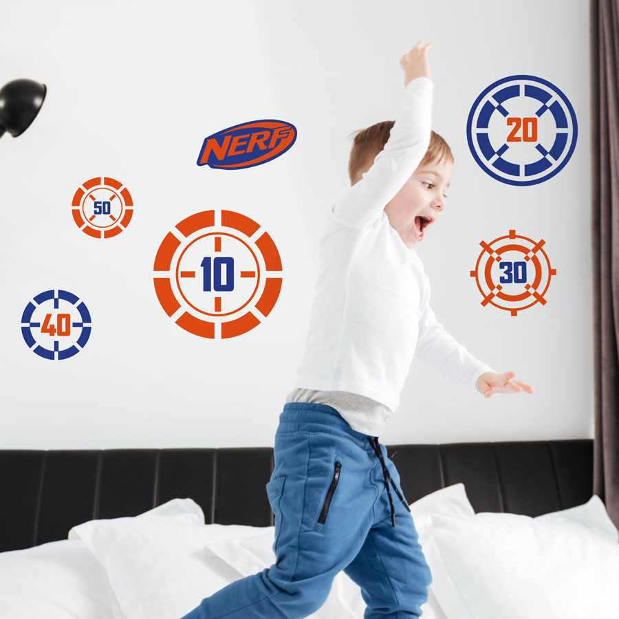 Nerf targets wall sticker pack regular shown on a white wall behind a child playing