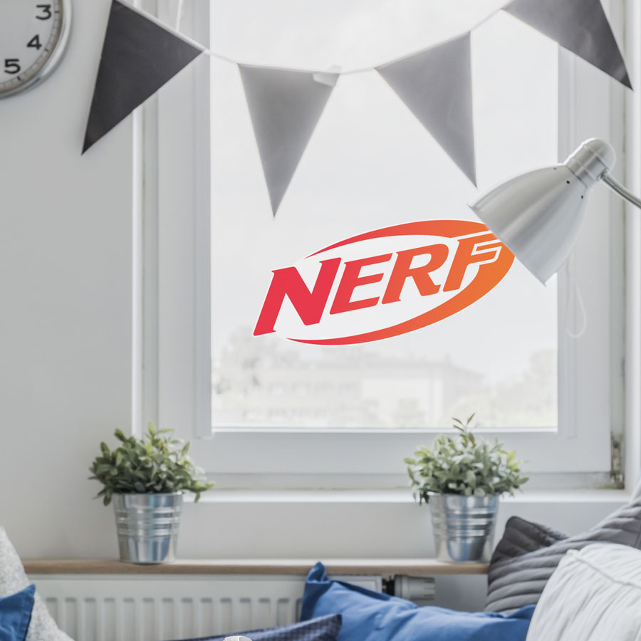 Nerf logo window sticker regular shown on a window behind grey bunting and a grey sofa