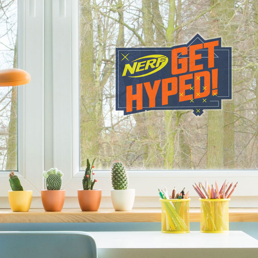 Get Hyped! Nerf window sticker regular shown on a window above a kitchen counter behind four cacti