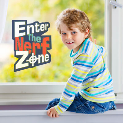 Enter The Nerf Zone window sticker shown on a window behind a child wearing stripes