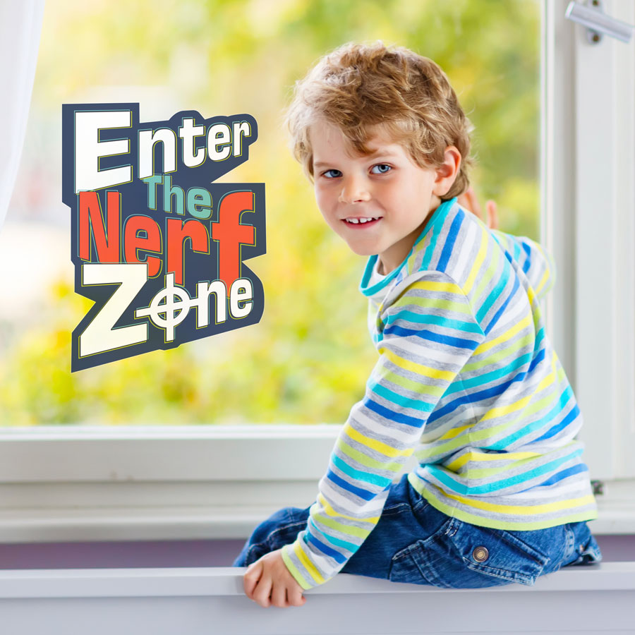 Enter The Nerf Zone window sticker shown on a window behind a child wearing stripes