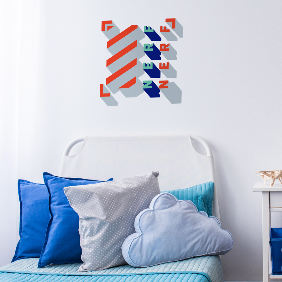 3D Nerf wall sticker regular shown on a white wall behind a blue and white bed