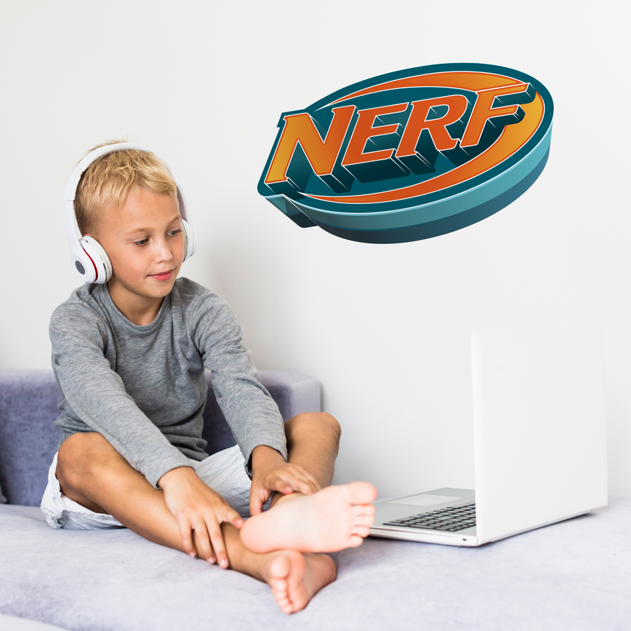 3D Nerf logo wall sticker large shown on a white wall behind a teenager on a laptop