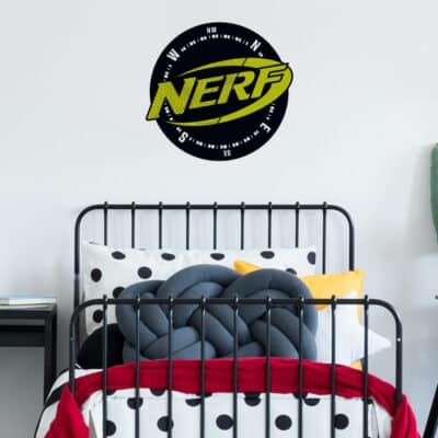 Nerf compass wall sticker large shown on a white wall behind a black bed with red, white and grey bedding
