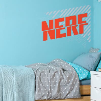 Split Nerf wall sticker shown on a blue behind a blue and grey bedspread