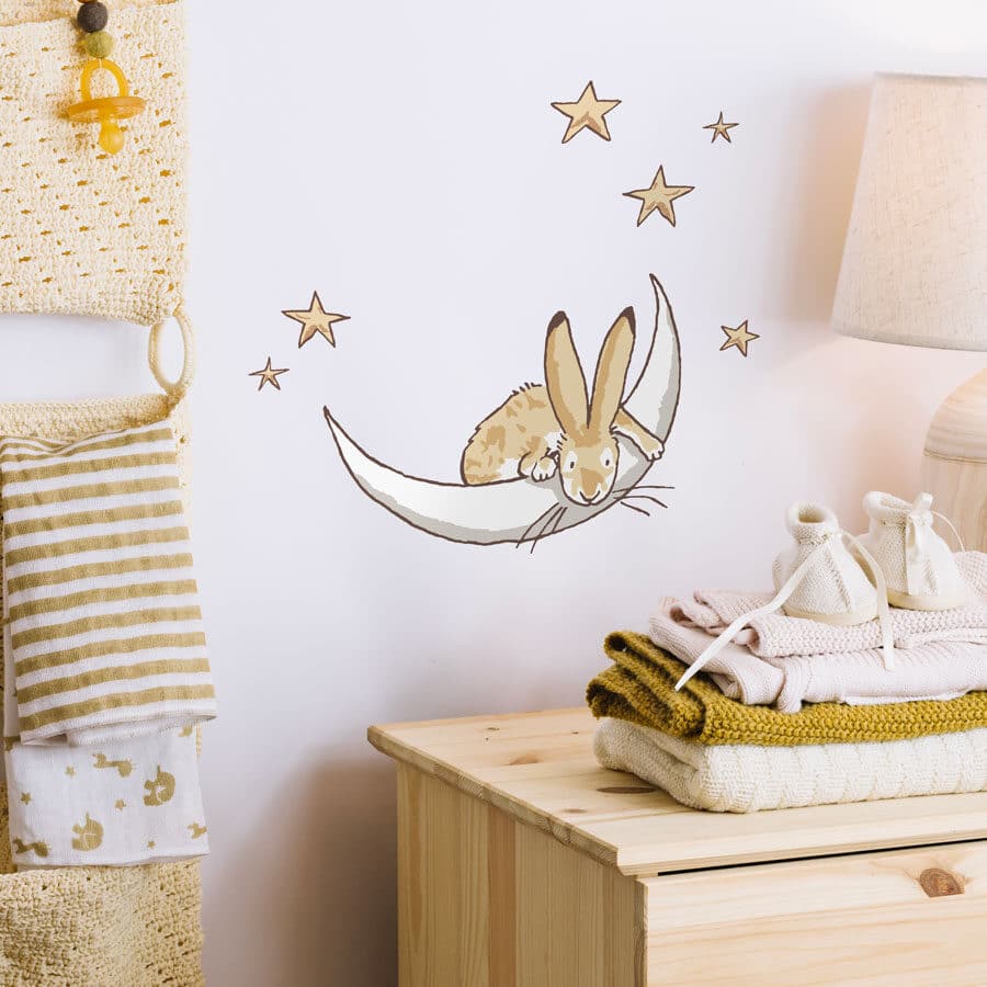Moon & stars wall sticker on a light coloured wall behind a light wooden dresser