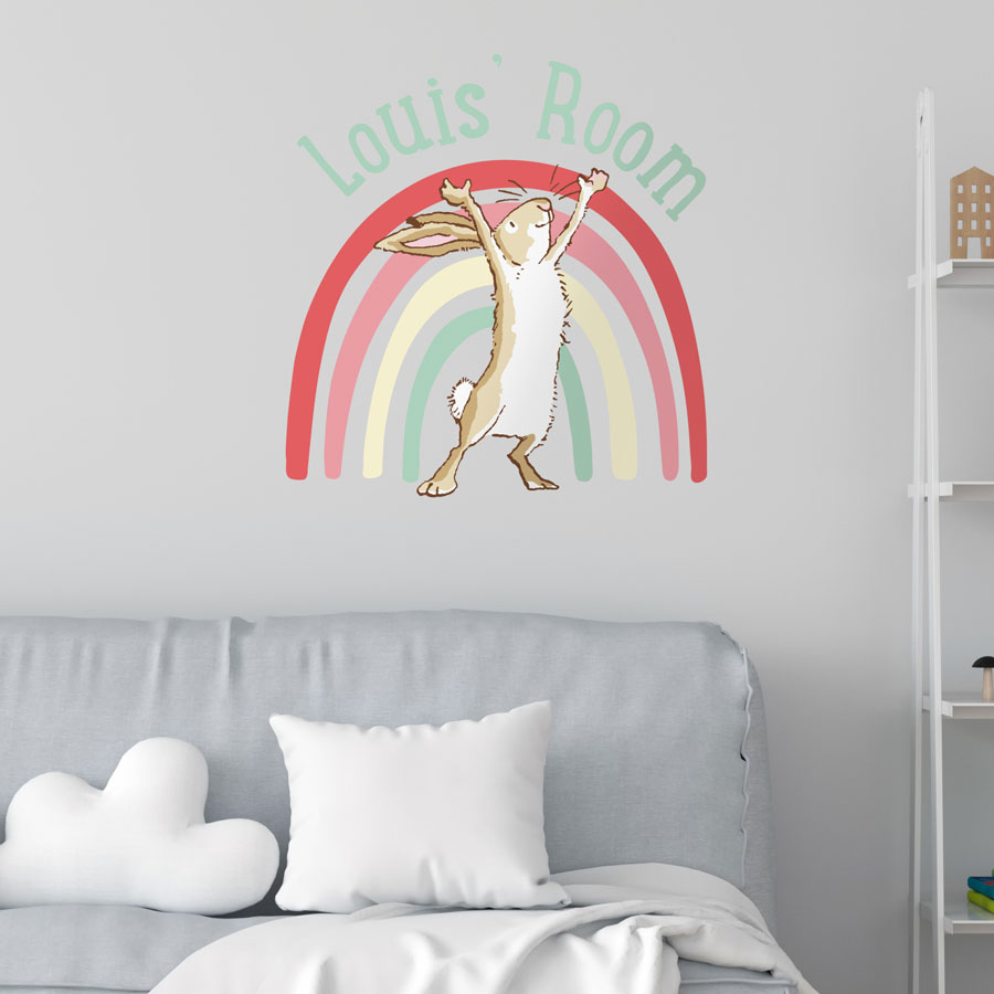 Personalised rainbow hare wall sticker large mint on a white wall behind a grey sofa