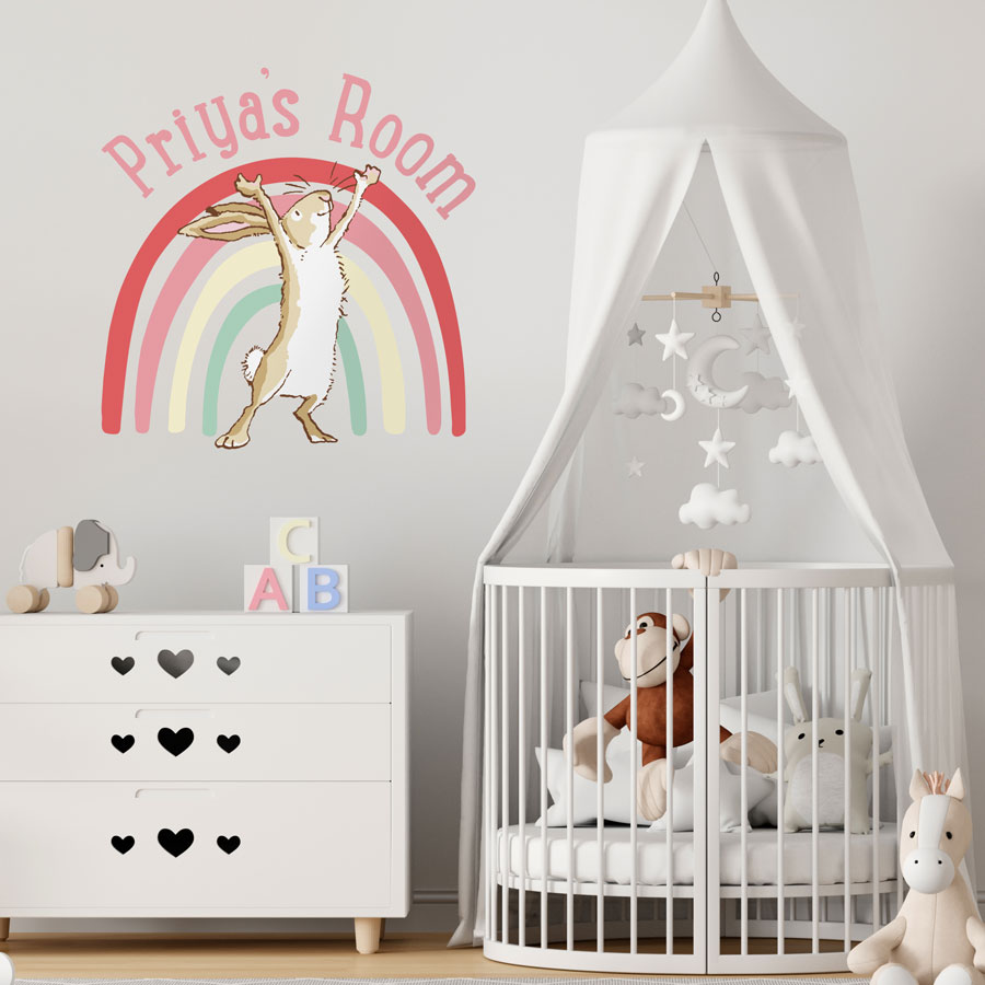 Personalised rainbow hare wall sticker large pink shown on a light grey wall above a white dresser