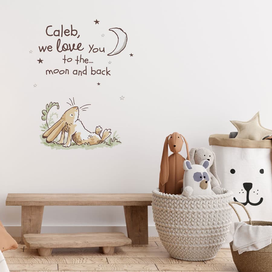 Personalised hare wall sticker shown on a white wall behind a wooden bench and storage baskets