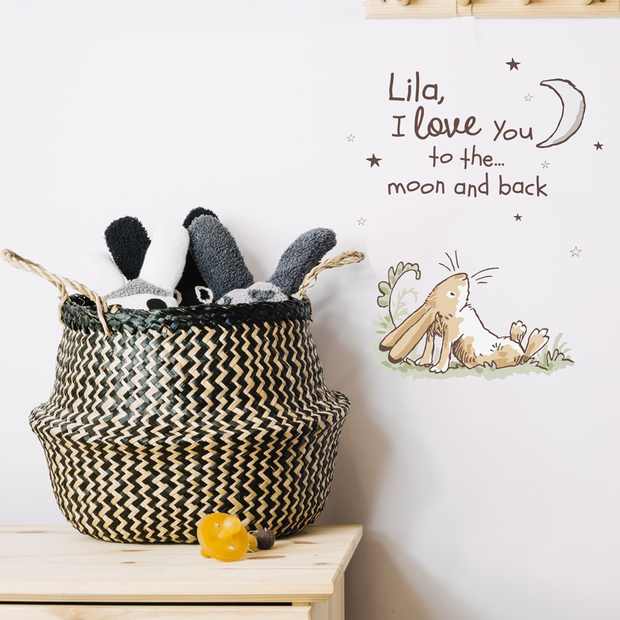 Personalised hare wall sticker shown on a white wall beside a storage basket