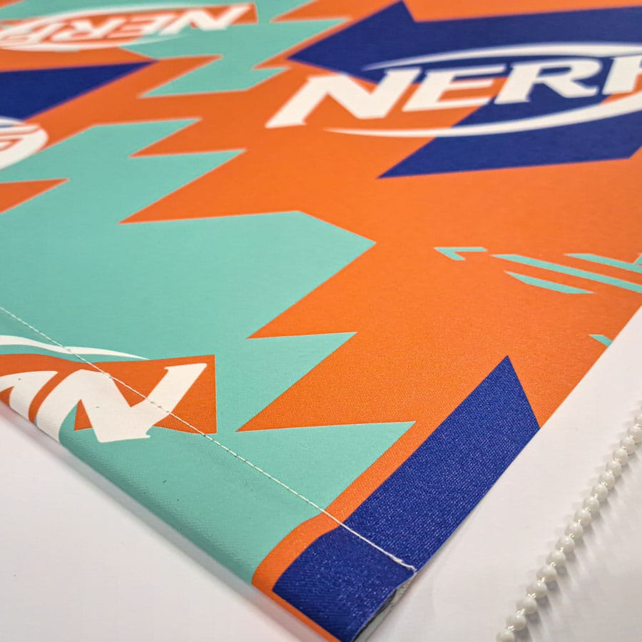 close-up of Orange Nerf roller blind showing blackout fabric