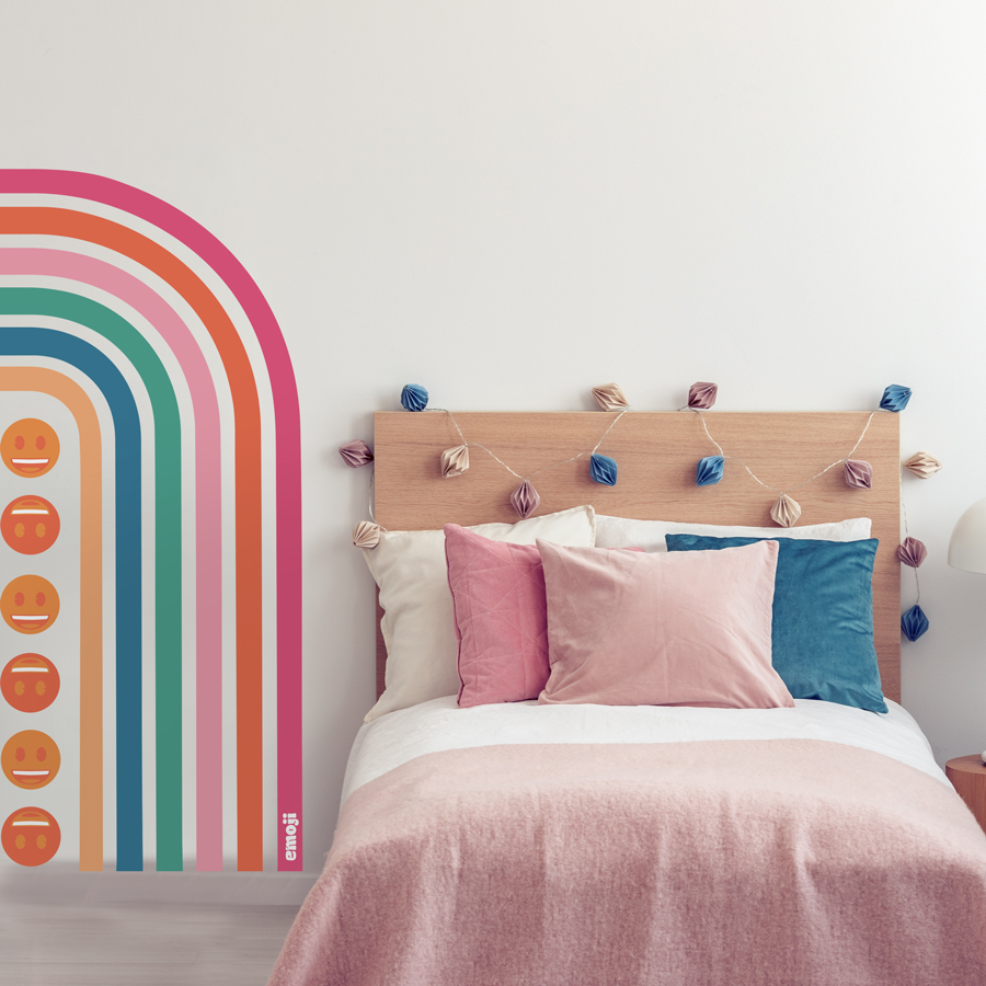 emoji half rainbow wall sticker show on a white wall next to a wooden bed with pink and blue bedding