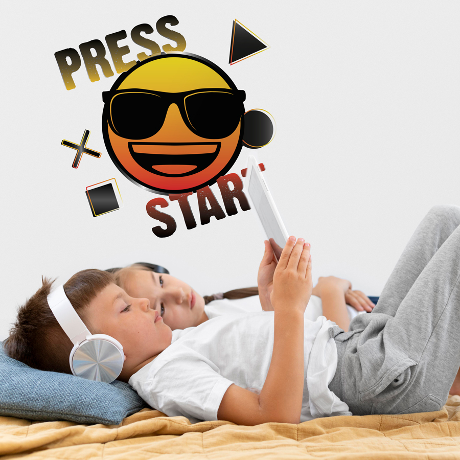 emoji press start wall sticker shown on a white wall behind two children watching an ipad