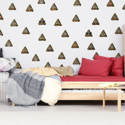 emoji poo wall sticker pack shown on a white wall behind a wooden bed with red and grey bedding