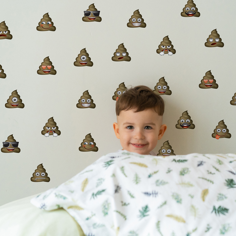 emoji poo wall sticker pack shown on a white wall behind a young child with a white blanket