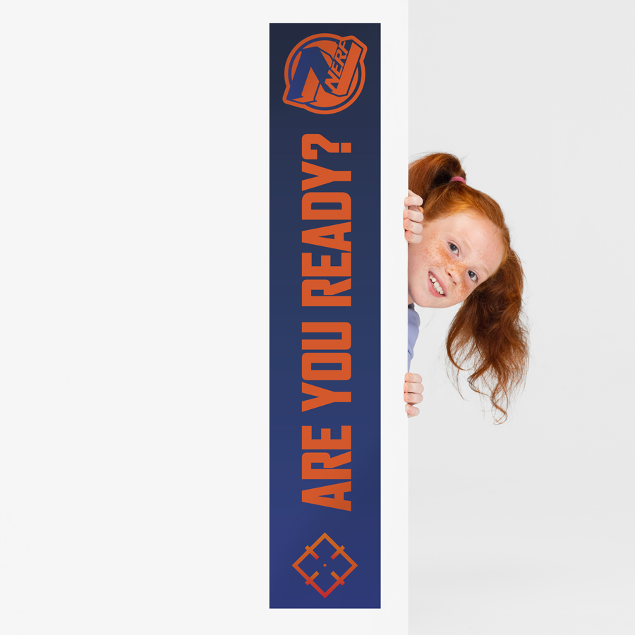 Nerf Party Stickers on a wall with a girl peering round