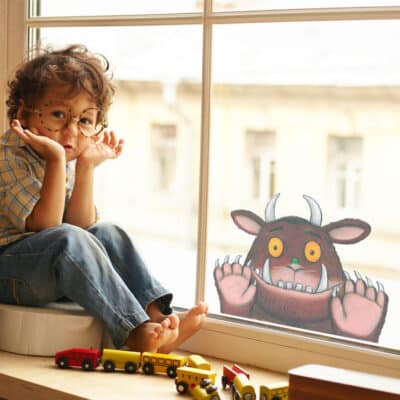 gruffalo window sticker on a window with a child