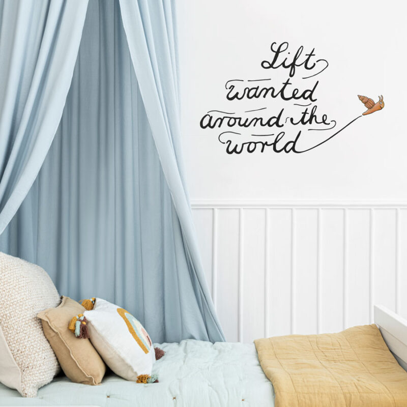 Snail and the Whale wall sticker above a child's blue bed