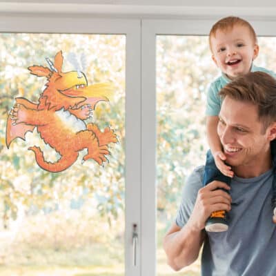 Zog Breathing Fire window sticker on a window with father and son