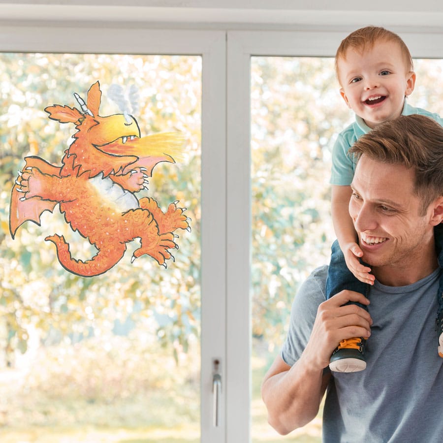 Zog Breathing Fire window sticker on a window with father and son