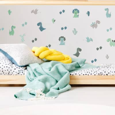 Pastel Dinosaur Wall Sticker in green on a white wall