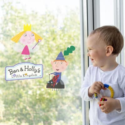 Ben & Holly Window Stickers on window behind child