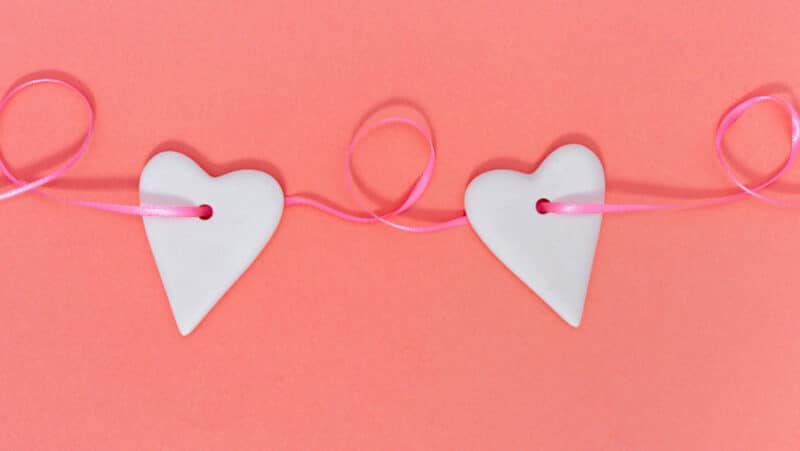 heart with holes on a string on a orange background arts and crafts