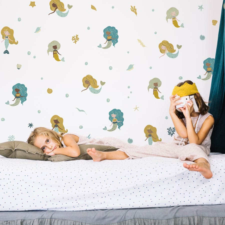 Mermaid and Sea Creatures Wall Stickers on a white wall behind two kids