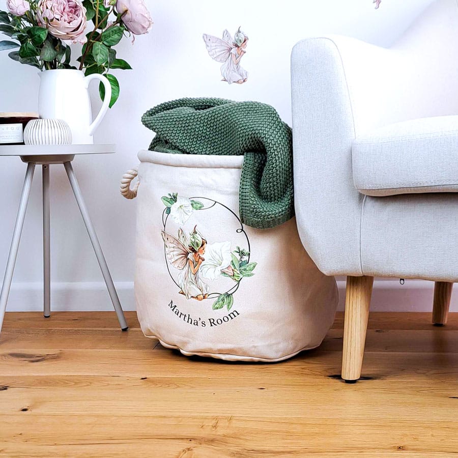personalised white bindweed storage trug with blanket and chair on wooden floor