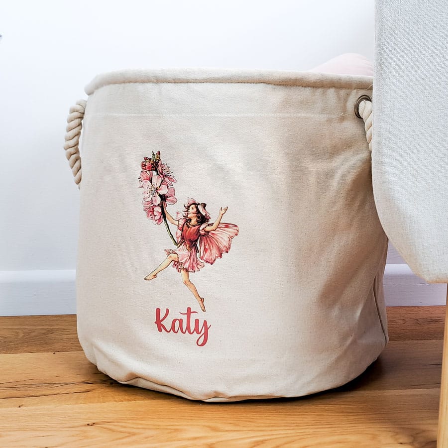 The Almond Blossom Storage Trug on a plain background and wood floor