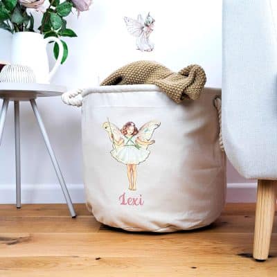 Personalised Christmas Tree storage trug in a room with flowers and a chair holding a blanket