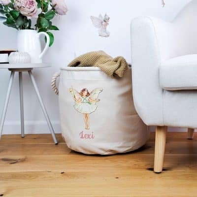 Personalised Christmas Tree storage trug in a room with flowers and a chair holding a blanket