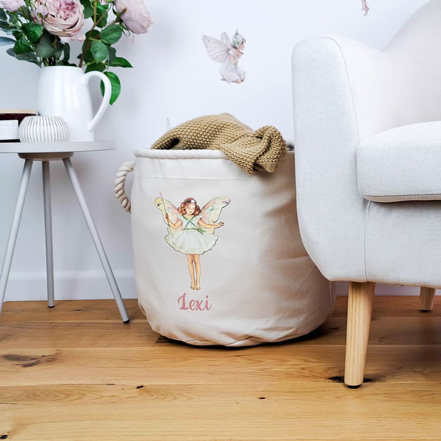 Personalised Christmas Tree storage trug in a room with flowers and a chair holding a blanket