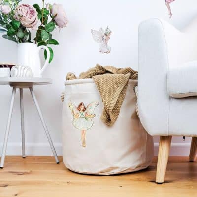 The Christmas Tree storage trug in a room with flowers and a chair holding a blanket