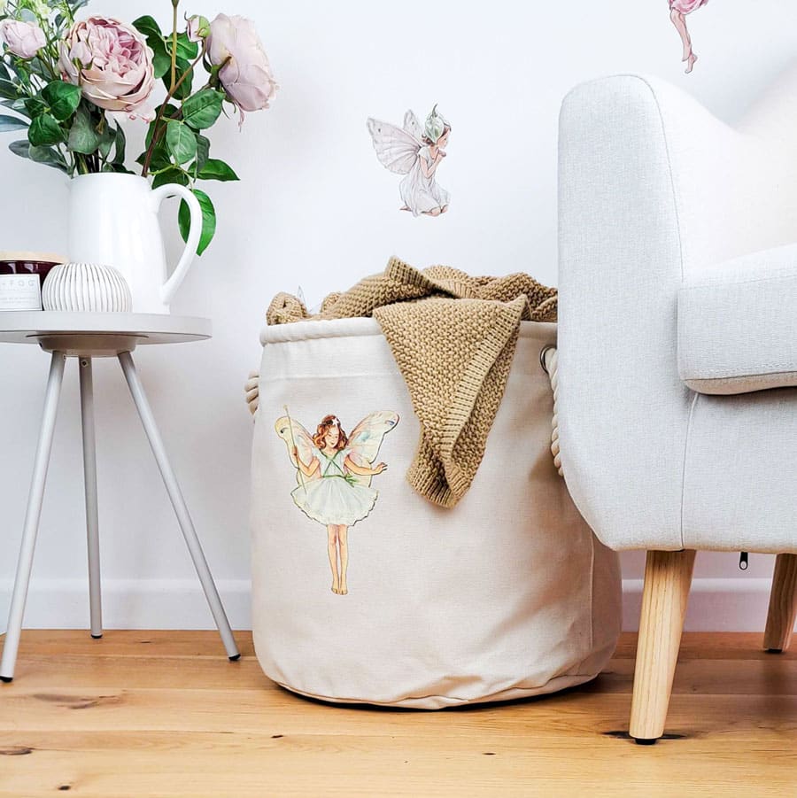 The Christmas Tree storage trug in a room with flowers and a chair holding a blanket