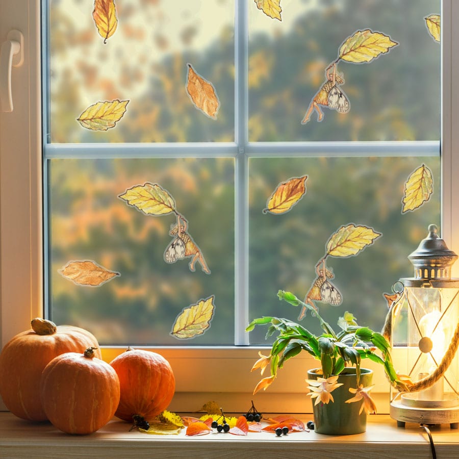 The Silver Birch Fairy window sticker on a window with autumnal decor