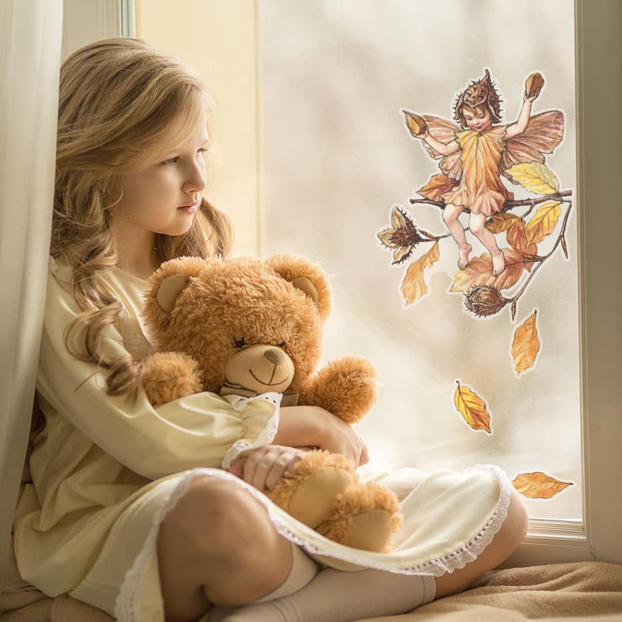 The Beechnut Fairy window sticker on a window with girl and teddy bear