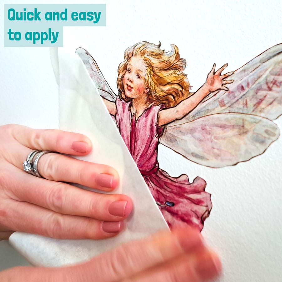 Pink Flower Fairies Wall Stickers being applied to the wall removing the transfer film