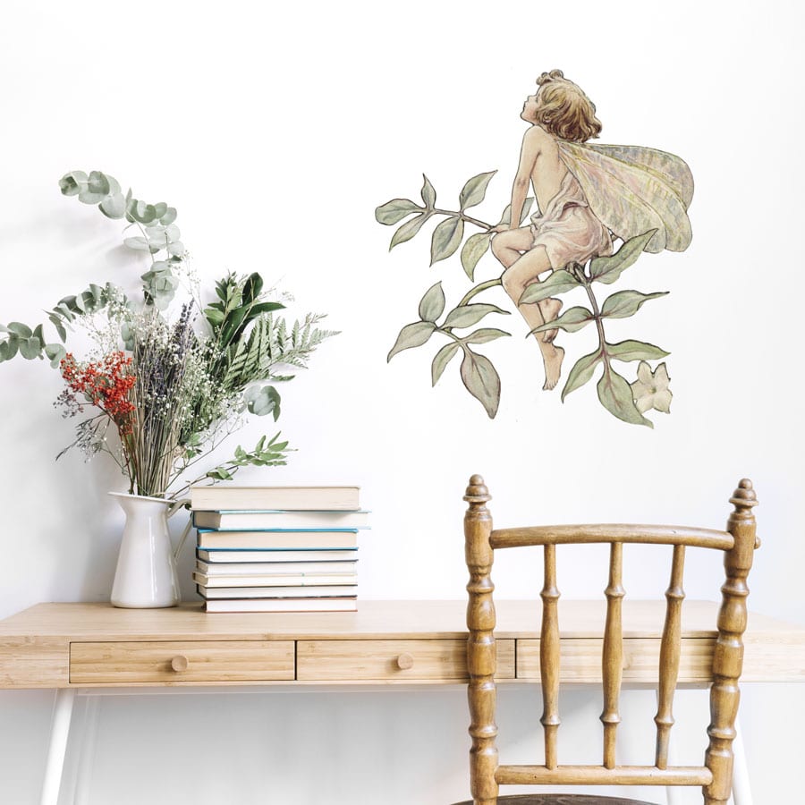 The Jasmine Fairy Wall Sticker on a white wall above a desk