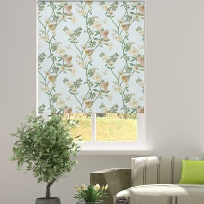 The Narcissus Flower Fairy roller blind in a window recess with a plant and sofa