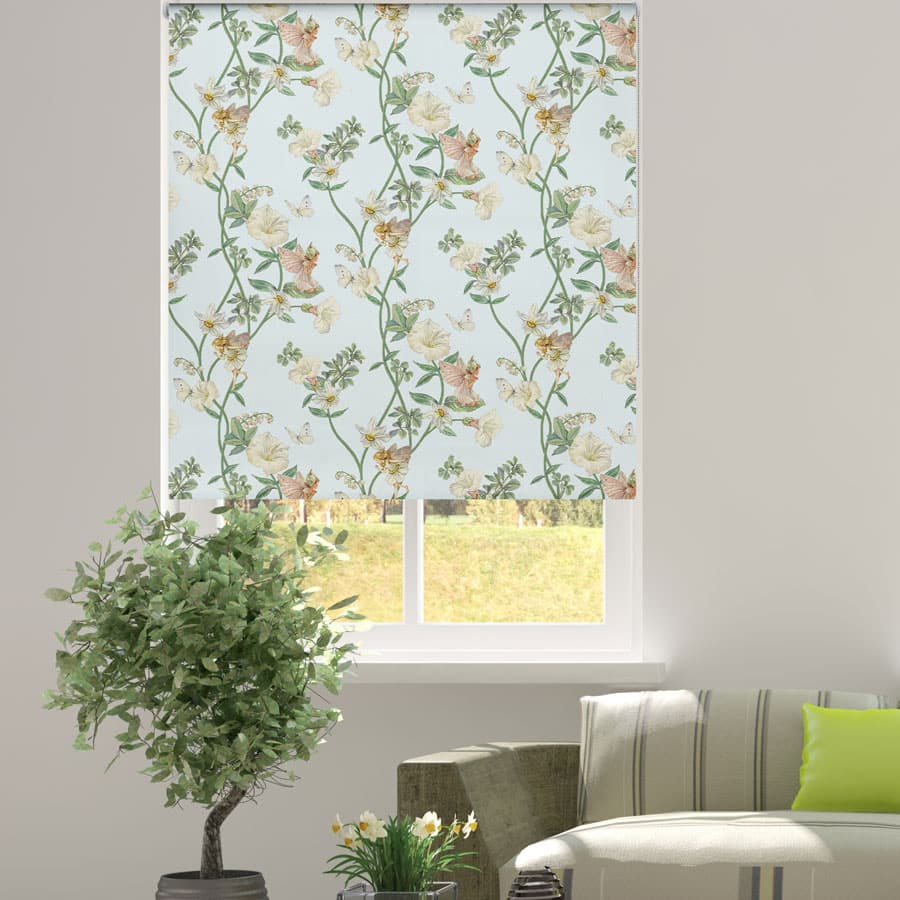 The Narcissus Flower Fairy roller blind in a window recess with a plant and sofa