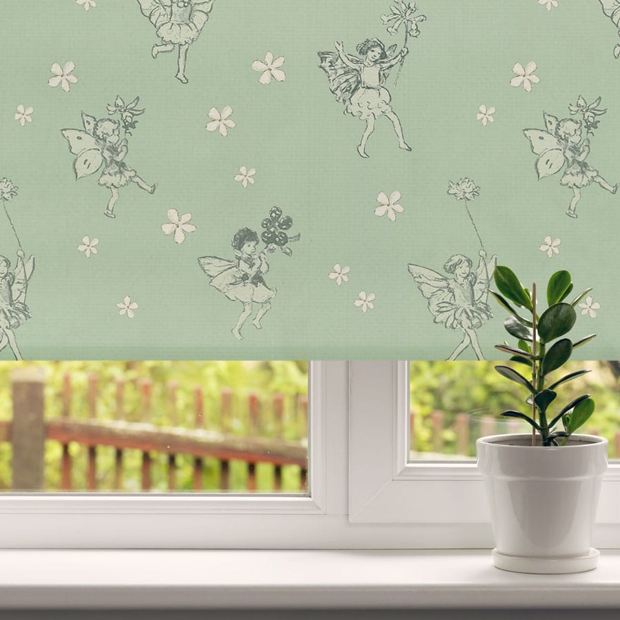 The Green Procession Flower Fairy roller blind close-up in a window with a pot plant