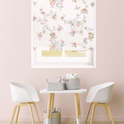 The Daydream Flower Fairy roller blind in a pink playroom with a desk and two chairs