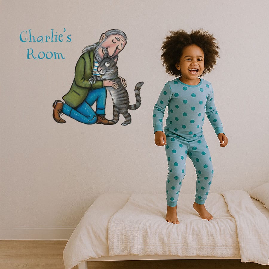 Personalised Tabby McTat Wall Sticker on a girl's bedroom wall with girl jumping on bed