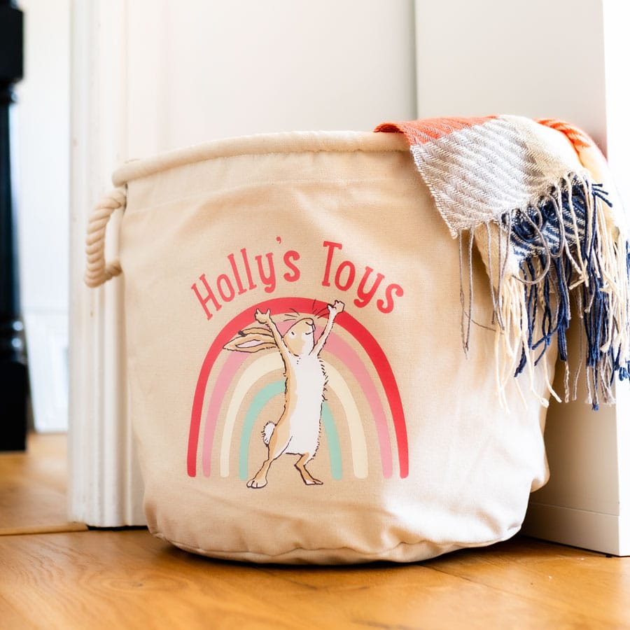 Guess How Much I Love You nursery storage basket with rope handles and personalised text, styled in a baby’s room for toy or blanket storage.
