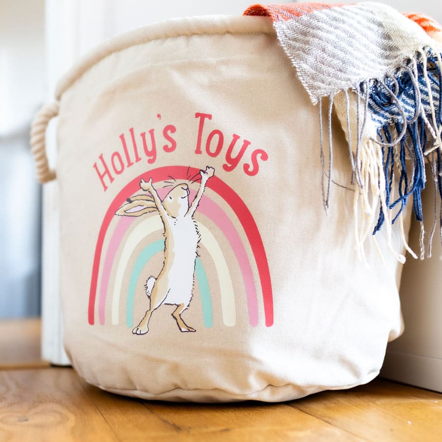 Canvas soft storage basket with Guess How Much I Love You rainbow illustration and name personalisation, perfect for baby’s nursery organisation.