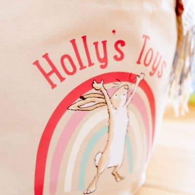 Close-up of a personalised Guess How Much I Love You soft storage basket, featuring Little Nutbrown Hare and rainbow design – ideal for nursery storage.