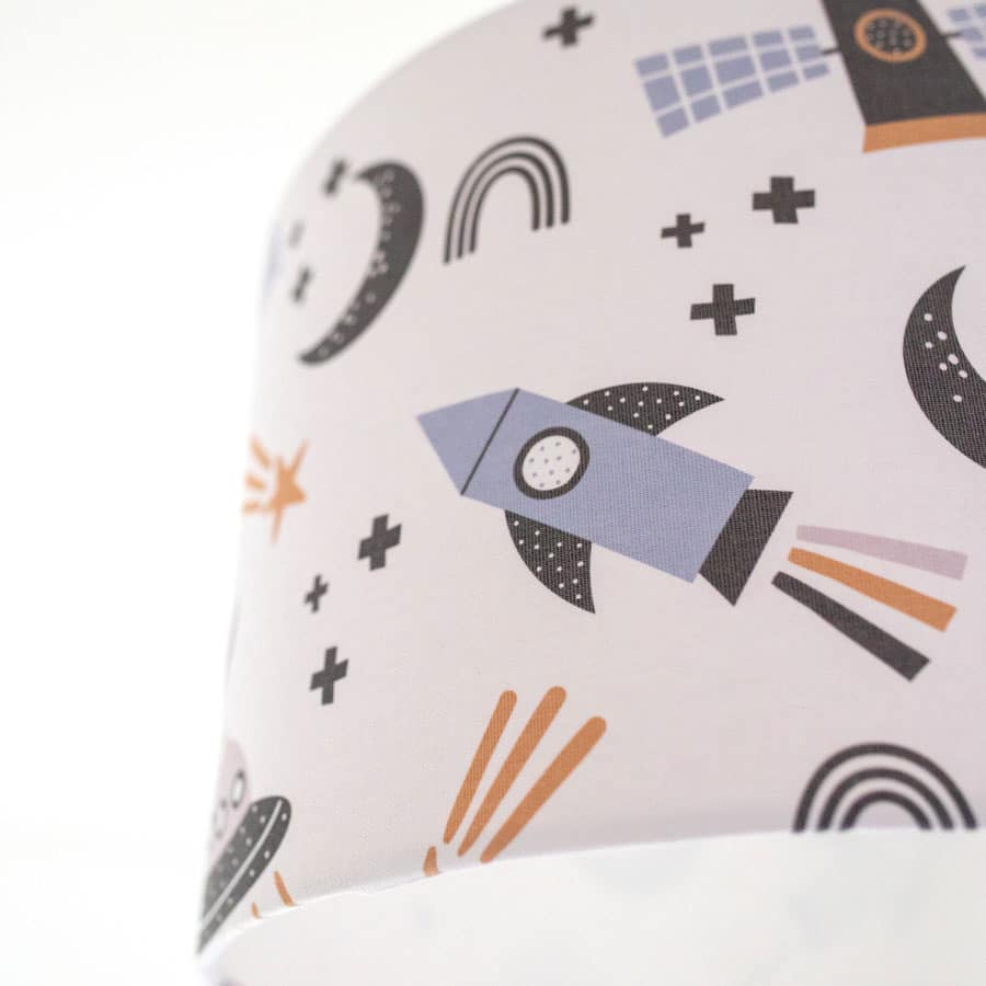 Close-up of scandi space lampshade showing rocket and spaceship pattern