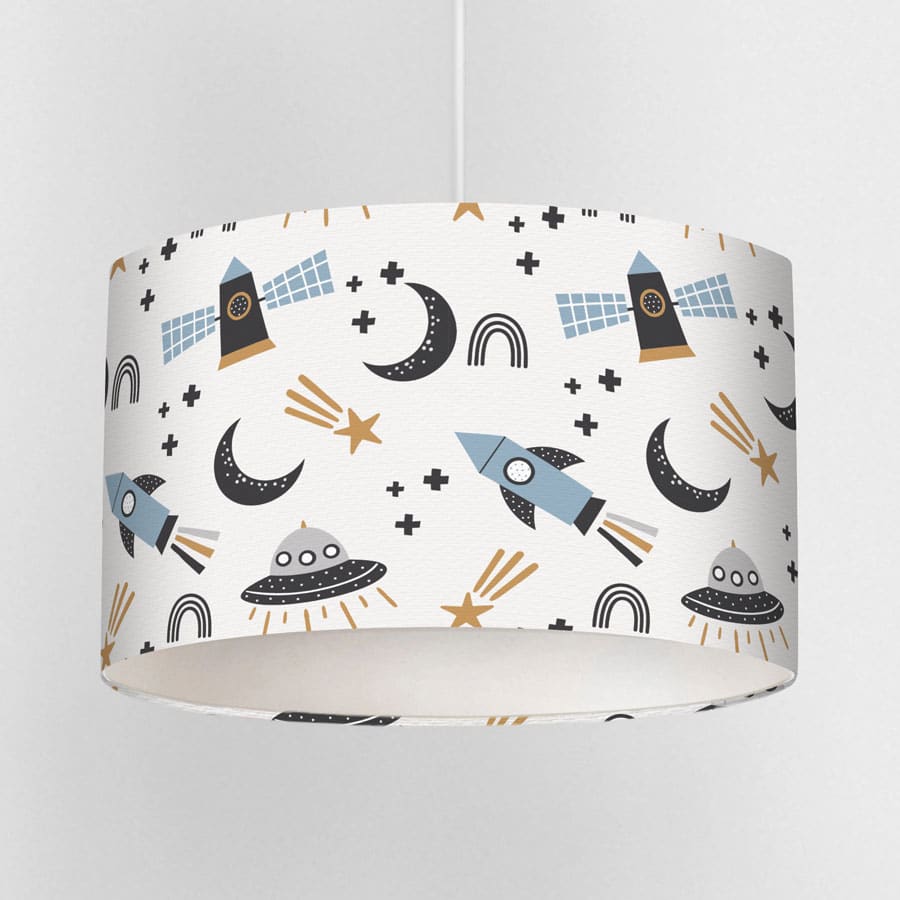 Close-up view of Scandi Space lampshade featuring rockets, stars, moons, and satellites in muted blue, black and mustard tones on a white background.